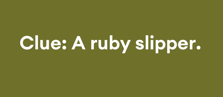 Which classic features a girl in ruby slippers seeking a way home?