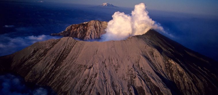 Which U.S. volcano is the champion of activity in the lower 48 states, boasting over 50 eruptions since 1700?
