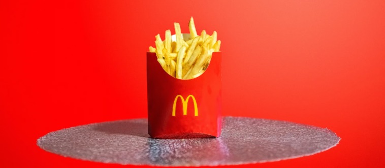 Which burger empire greets hungry travelers with those iconic golden arches?
