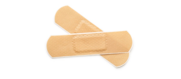 What is the go-to adhesive solution most folks grab first for a tiny nick or scrape?